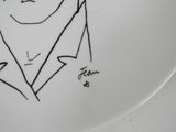 a plate with a drawing of a man in a suit on it