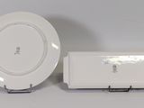 a white plate sitting next to a white plate on a table
