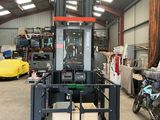 a forklift in a warehouse with a lot of boxes