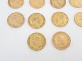 six different types of gold coins on a white surface