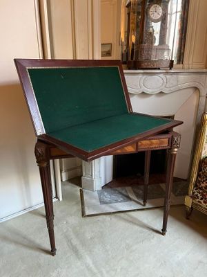 a small table with a green cover on it in a room