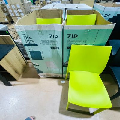 a yellow chair sitting in front of a pile of boxes