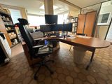 a desk with a chair and a computer on it