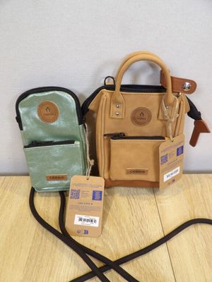 a purse, a wallet, and a cell phone on a table