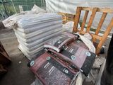 a pile of books and bags on a pallet in a warehouse