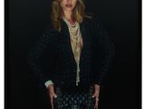 an image of a woman in a black jacket and skirt posing for a picture