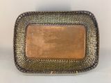 a close up of a metal tray with a brown leather label on it
