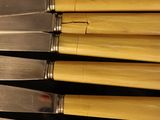five knives that are sitting next to each other on a table