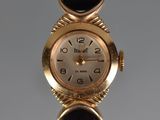 an image of a close up of a wrist watch on a black strap