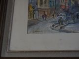 a picture of a painting of a street scene in a frame