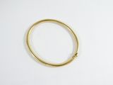 a close up of a gold ring on a white surface