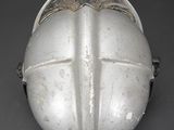 a helmet with a cross on it sitting on a table