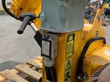 a yellow machine that is sitting on a pallet