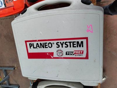 a white toilet with a red and black sticker on it