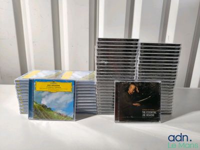a lot of cds on a table with a white chair
