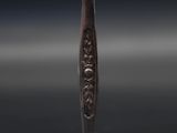 a close up of a metal object on a black surface