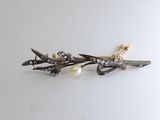 a close up of a pair of hair clips on a white surface