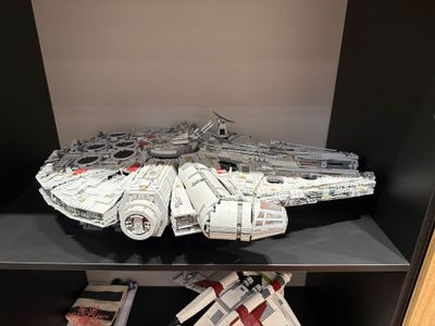 lego star wars millennium fighter on display in a bookcase