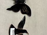two black birds that are sitting on a table