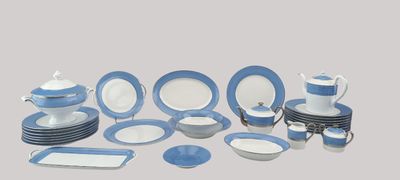 blue and white dinnerware set on a table with a gray background