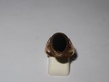 an image of a gold ring with a black stone on it