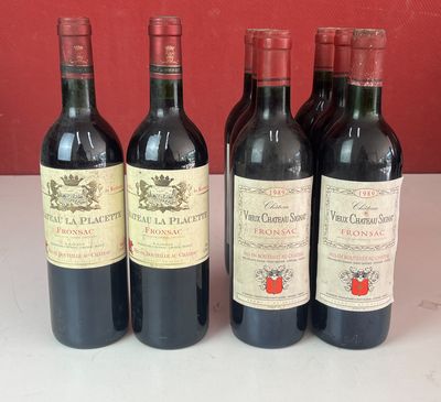 plusieurs bouteilles de vin sont alignées sur une table