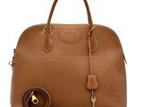 a brown leather handbag with a key on the handle
