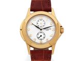 a yellow gold wrist watch with a white dial and brown leather strap