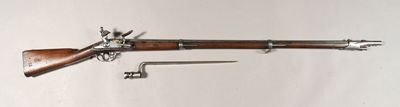un vieux fusil avec un canon en bois et une poignée en métal