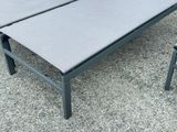 a bench and a table on the gravel ground