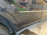 a close up of a car door with a sticker on it