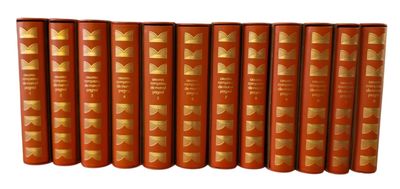 six red books with gold covers are lined up on a white surface