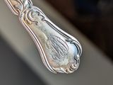a silver spoon that is sitting on top of a table