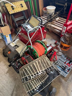 a picture of a pile of tools and tools in a garage