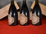 three bottles of wine that are sitting on a table
