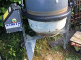 an old cement mixer sitting in the yard