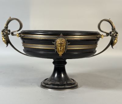 a black and gold bowl with a lion head on it