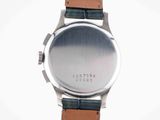 a close up of a watch on a white surface