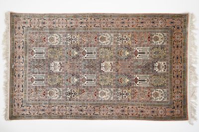 an antique persian rug with a floral design and fringe fringes