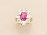 an oval ruby and diamond cluster ring