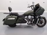 a green motorcycle that is parked in a room