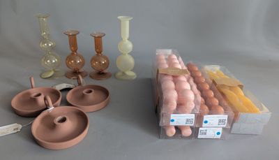 many different types of vases and candles on the table