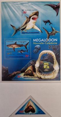 a close up of a stamp with a shark and other animals on it