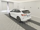 the rear end of a white car is parked in a garage