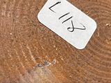 a close up of a piece of wood with a sticker on it