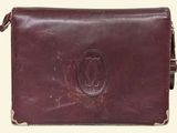 an image of a brown leather purse with a monogram on it