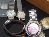 a lot of watches that are sitting on a table