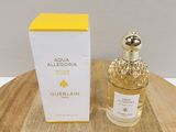 a bottle of perfume sitting on top of a wooden table