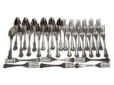 a lot of forks and spoons on the table