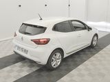 the rear end of a white car parked in a garage